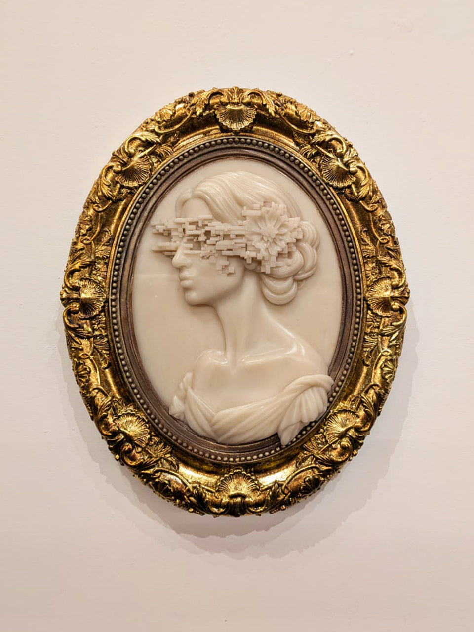 Charlotte Brontë Cameo — resin and 24k gold leaf by JoCa: an ivory cameo profile with curled hair, a glitch band across the eyes, in an ornate gold oval frame